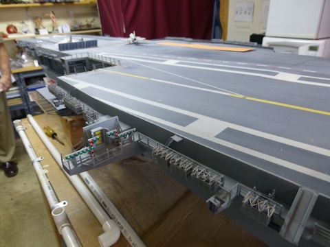 Escalator to deck level island superstructure  on starboard side of hull